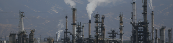 A picture of a factory emitting smoke and other gases.